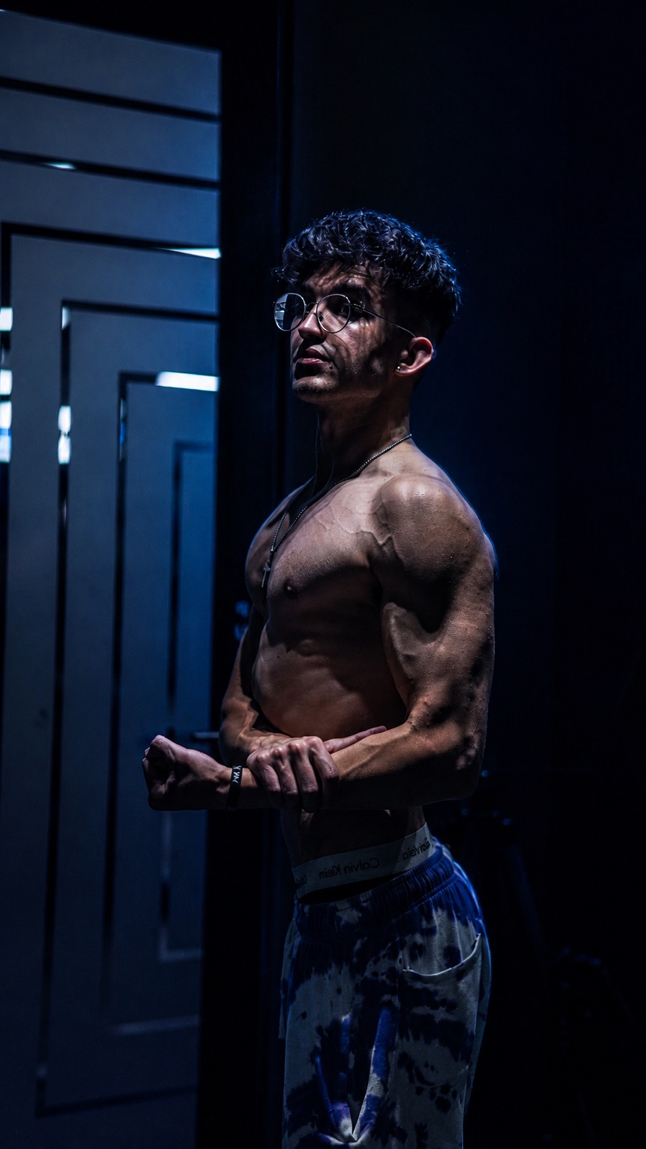 Revelion Imperium founder, a former coach, standing in low blue light